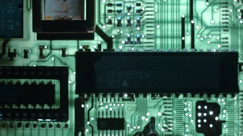 A printed circuit board with microchip whitch cast shadows that follow the light Stock Footage 268891952