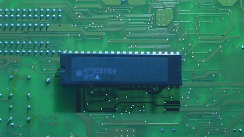A printed circuit board with microchip whitch cast shadows that follow the light Stock Footage 268893223