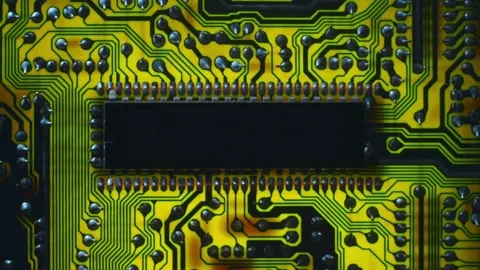 A printed circuit board with microchip whitch cast shadows that follow the light Stock Footage 268893990