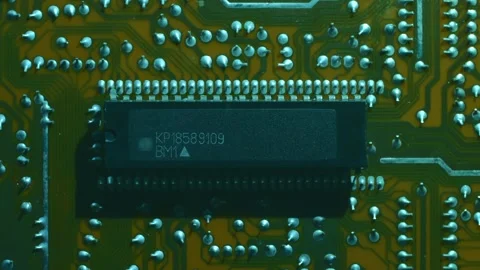 A printed circuit board with microchip whitch cast shadows that follow the light Stock Footage 268894236