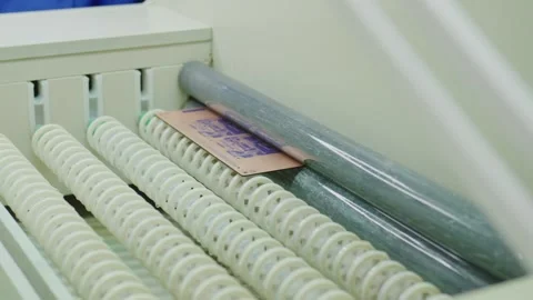 Printed circuit board moving through rollers in manufacturing process Stock Footage 316542147