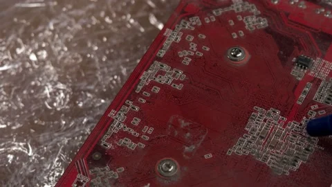 The printed circuit Board of the red video card is cleaned from dust by a pear Stock Footage 131152603