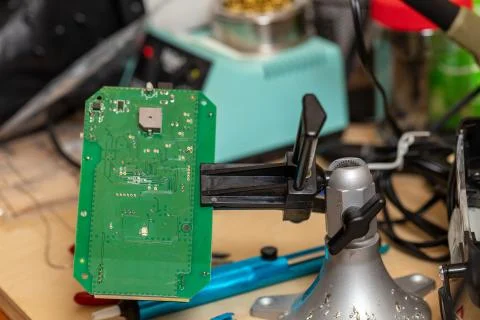Printed circuit board in vice on workbench Stock Photos