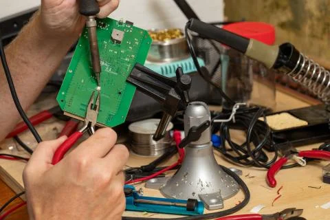 Printed circuit board in vice on workbench Stock Photos