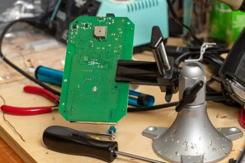 Printed circuit board in vice on workbench Foto stock