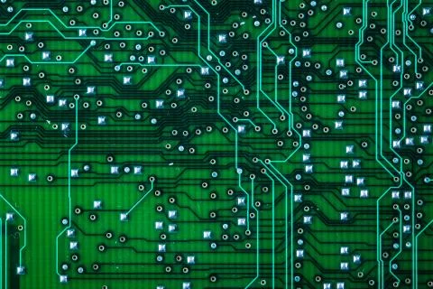 Printed green computer circuit board with many electrical components Stock Photos