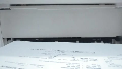 The printed paper comes out of the printer machine 動画素材 202433432