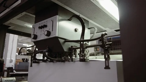 Printed sheet of paper coming out from printing machine. Offset printing, CMYK Stock Footage 110797898