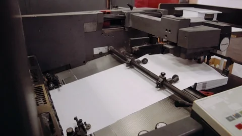 Printed sheet of paper coming out from printing machine. Offset printing, CMYK Stock Footage 110798186