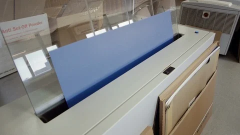 Printed sheet of paper coming out from printing machine. Offset printing, CMYK Stock Footage 110798737