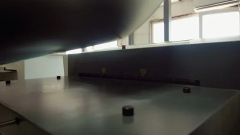 Printed sheet of paper coming out from printing machine. Offset printing, CMYK Stock Footage 110798744