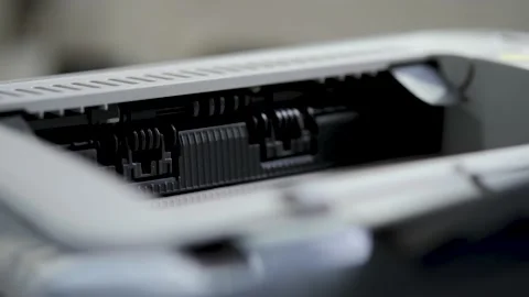 A printed sheet of paper is coming out from the exit of the office printer Stock Footage 159842144