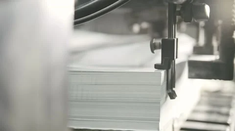 Printed sheets of paper are served in the printing press. Offset printing, CMYK 動画素材 67731986