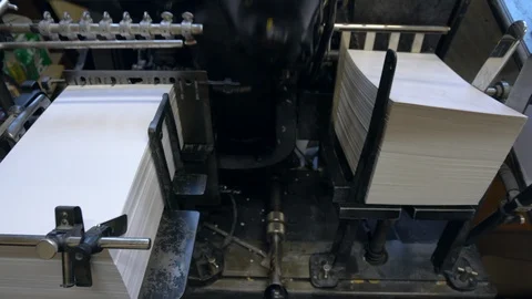 Printed sheets of paper are served in the printing press Stock-Footage 120896382