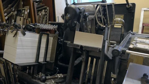 Printed sheets of paper are served in the printing press Stock-Footage 120897402
