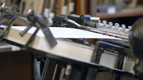 Printed sheets of paper are served in the printing press Stock-Footage 120897650