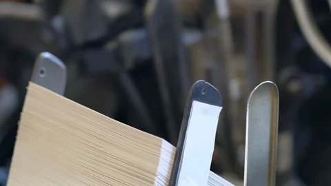 Printed sheets of paper are served in the printing press Stock-Footage 120897782