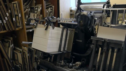 Printed sheets of paper are served in the printing press Stock-Footage 120897940