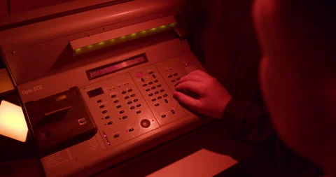 Printer adjusts De Vere Opto ECU controller under safelight in darkroom. Stock Footage 313980827
