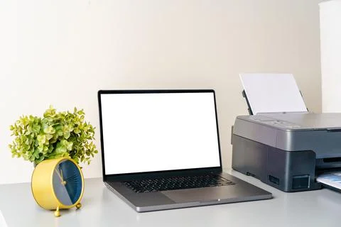 Printer and laptop on grey table in office Foto stock
