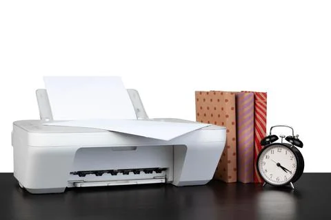 Printer and stack of books on black table against white background 写真素材