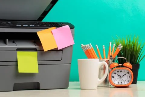 Printer, copier, scanner on color background . Office table Stock Photos
