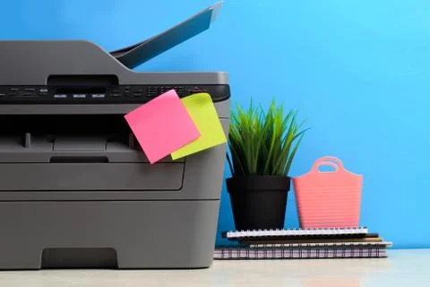 Printer, copier, scanner on color background . Office table Stock Photos
