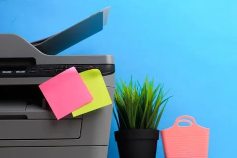 Printer, copier, scanner on color background . Office table Stock Photos