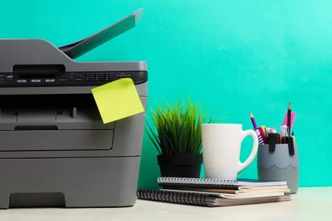 Printer, copier, scanner on color background . Office table Stock Photos