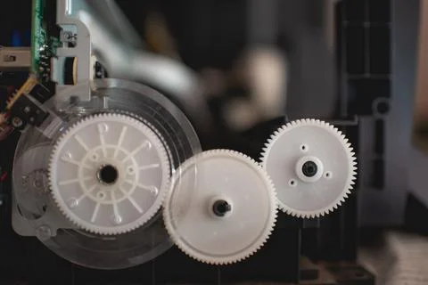 The printer that has been disassembled for repairs has colored gears and inte Foto stock