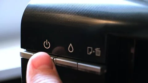 The printer has a green indicator light and an orange warning light indicating a 库存照片