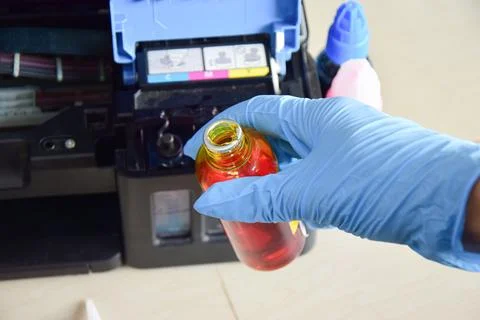 Printer ink; Refilling ink for refillable printers. Stock Photos