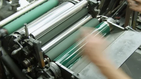 A printer inking up the rollers on a Heidelberg platen press. Getting Stock Footage 102192739