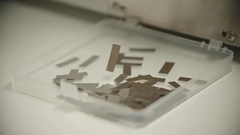 Printer machine cutting and ejecting small metal strips Stockbeeldmateriaal 347725958