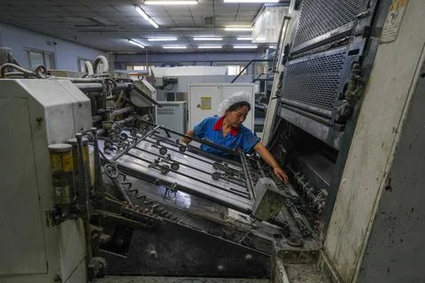 Printer Operating Printing Machine to Check Printing Effect on Paper Stock Photos