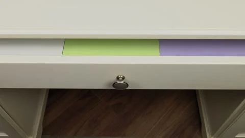 Printer papers of different colors are laid out in a desk drawer Video stock 295032760