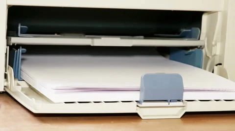 The printer picks up the sheets from the tray Stock Footage 67634329