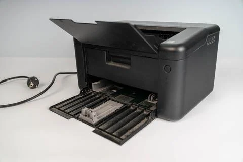 Printer placed on a white background with a power cord attached Fotos Stock