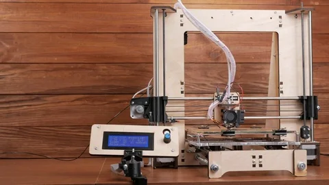 The printer prints the gear. The display shows information about nozzle Stock Footage 77949310