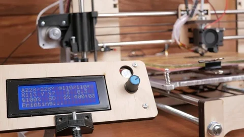 The printer prints the gear. The display shows information about nozzle Stock Footage 77949636