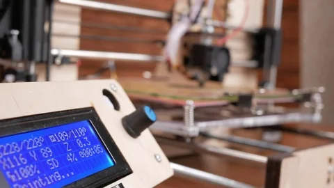 The printer prints the gear. The display shows information about nozzle Stock Footage 77950540