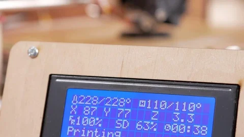 The printer prints the gear. The display shows information about nozzle Stock Footage 77954540