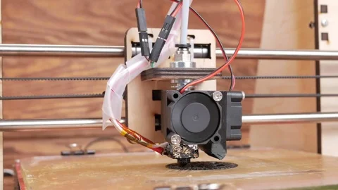 The printer prints the gear. A layer by layer appears on the desktop Stock Footage 77950921