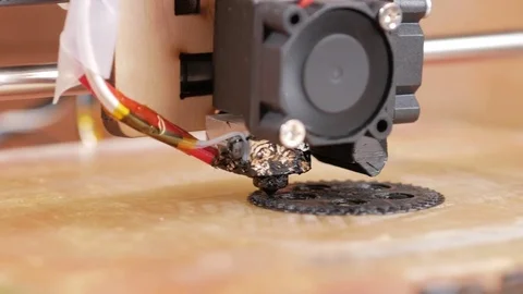 The printer prints the gear. A layer by layer appears on the desktop Stock Footage 77952275