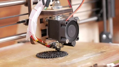 The printer prints the gear. A layer by layer appears on the desktop. Moving Stock Footage 77953880