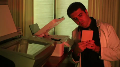 Printer repair guy looking manual 스톡 동영상 36009431