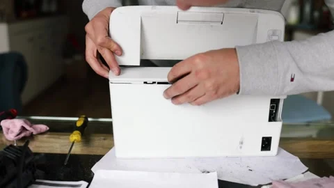 Printer repairman inspecting printer interior. Concept of professional printer Stock Footage 289773627