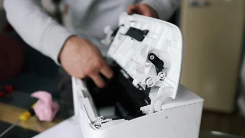 Printer repairman inspecting printer interior. Concept of professional printer Stock Footage 289773646