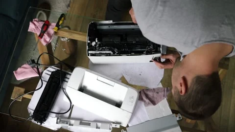 Printer repairman inspecting printer interior. Concept of professional printer Stock Footage 289773707
