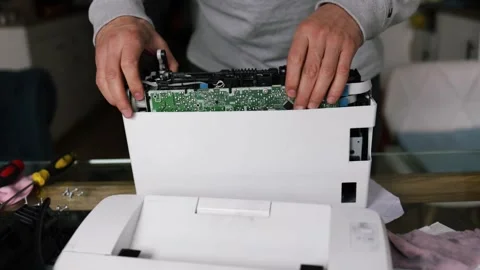Printer repairman inspecting printer interior. Concept of professional printer Stock Footage 289773765